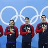 The U.S. goid medal 4x100-meter medley team listens to the controversial arrangement of the national anthem at the Olympic Aquatics Stadium in Rio.