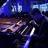 Drew Petersen plays the piano in The Greene Space