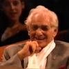 Leonard Bernstein laughs as Lauren Bacall serenades him in 1988