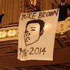 A St. Louis Symphony protester unfurls a banner at Powell Hall