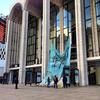 Workers hoist the banners in front of the Metropolitan Opera after Sandy