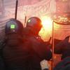 	Demonstrators (back), protesting against the Italian government's austerity budget cuts, clash with riot policemen outside La Scala