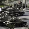 Bahraini army tanks take position near Pearl Square in Manama on February 17, 2011