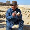 Zahi Hawass, the head of Egypt's Supreme Council of Antiquities, holding a bust believed to be of Cleopatra and a mask of Marc Anthony.
