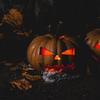 two jack-o-lanterns set on foreground with dark background